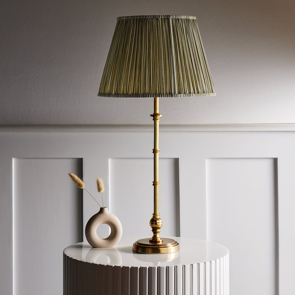 Chukka cordless table lamp in antique brass