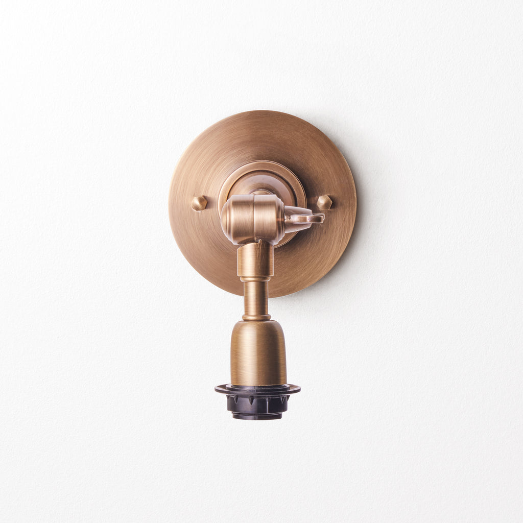 Mumford wall fixture in antiqued brass