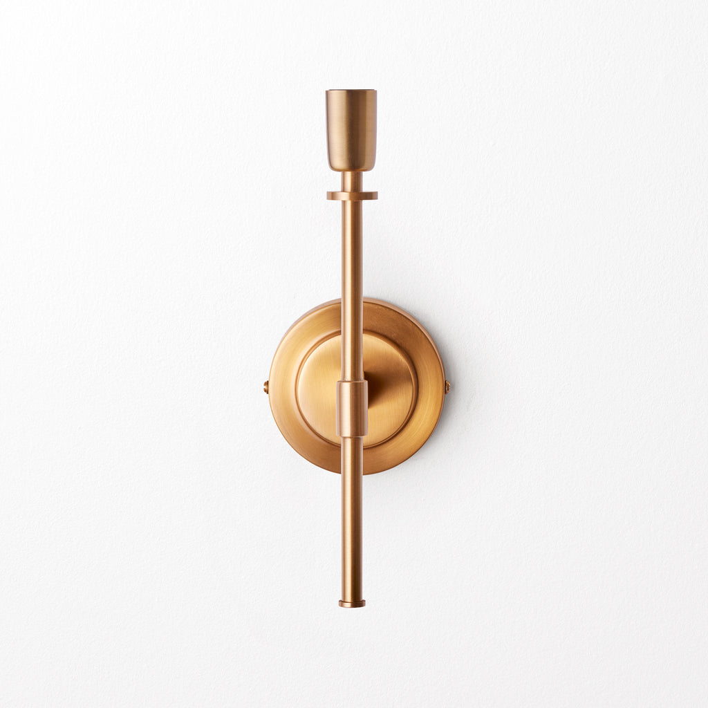 Tremmers wall fixture in antiqued brass