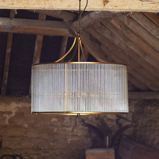 Artemis Chandelier in antiqued brass with glass rods and frosted glass baffle
