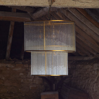 two tiered Loki chandelier in antiqued brass with glass rods