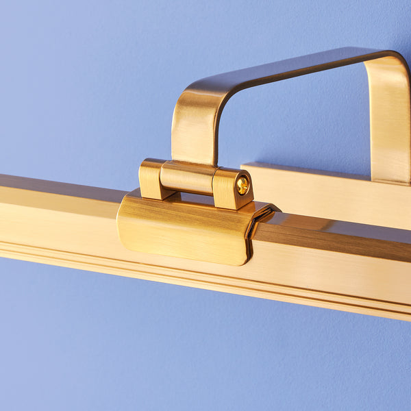 Larger Marcel cordless picture light in antique brass finish