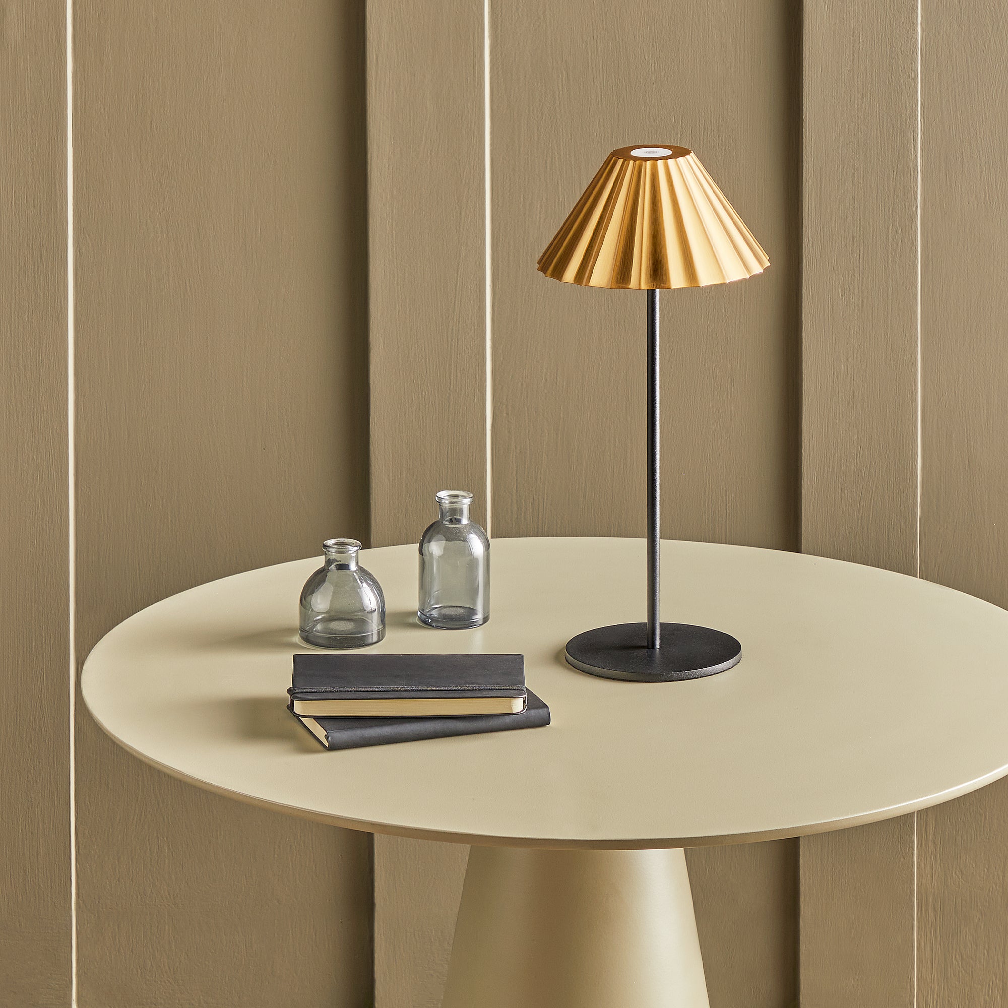 Twinky cordless table lamp in black with an antiqued brass hood