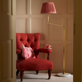 Cranling articulated floor lamp in antiqued brass with a white marble base