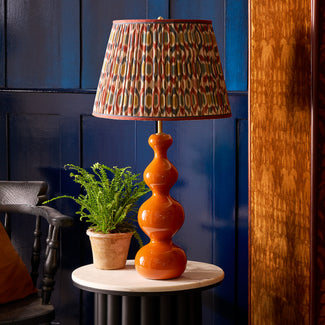 Smaller Wobster table lamp in burnt orange lacquered wood