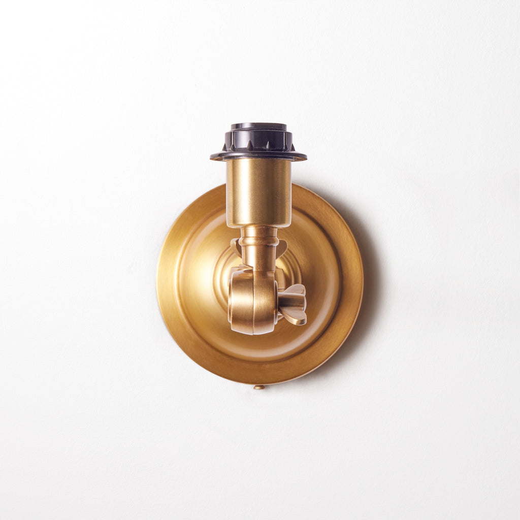 Double jointed wall fixture in antiqued brass