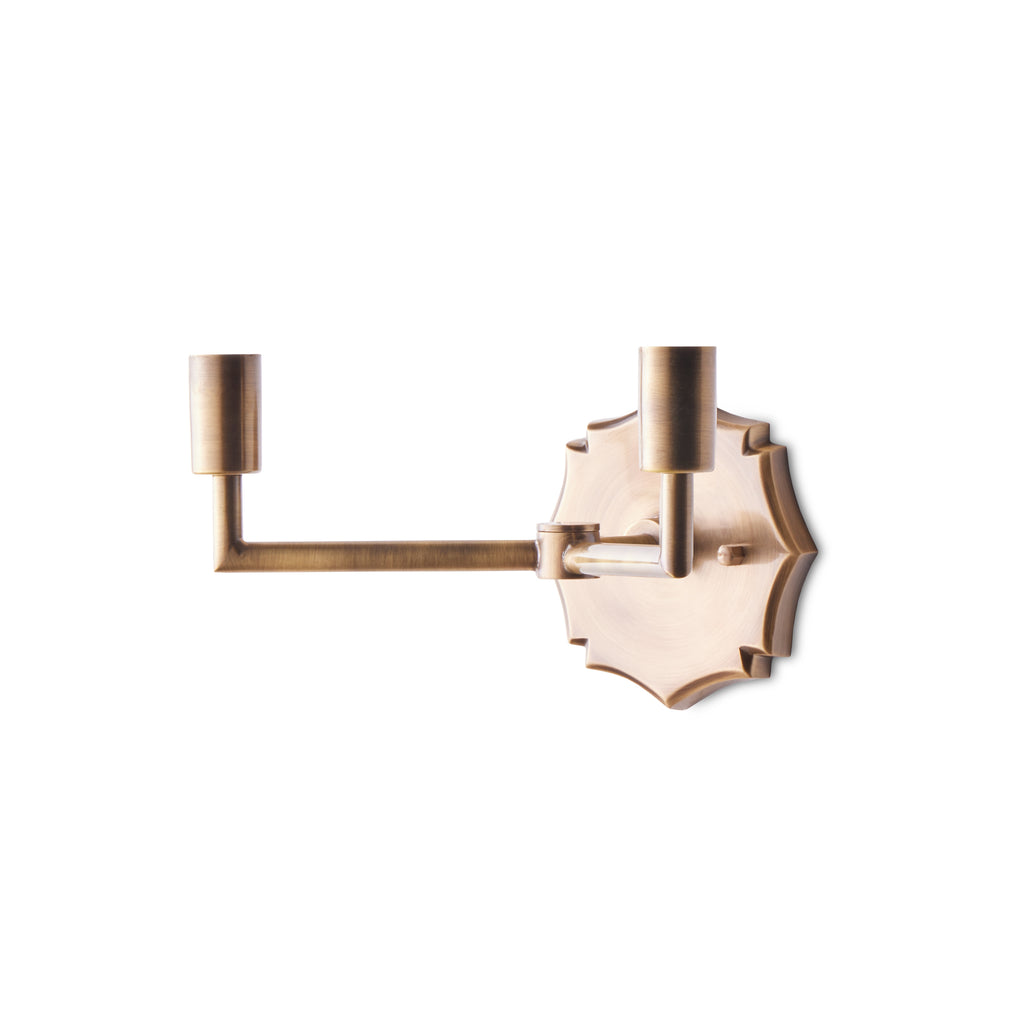 Double insignia wall fixture in antiqued brass