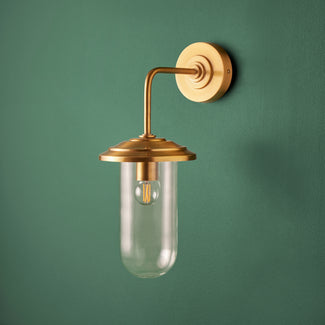 Curlew wall sconce in antiqued brass