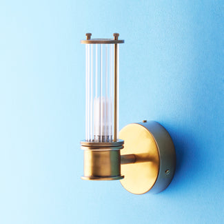Smaller Hunter wall sconce in antiqued brass and glass