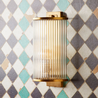 Roddy wall sconce in antiqued brass with glass rods