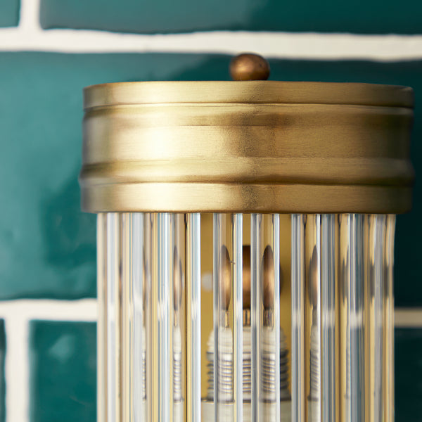 Long Roddy wall sconce in antiqued brass with glass rods