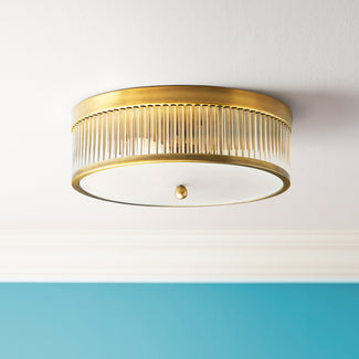 Round Roddy flush mount ceiling light in antiqued brass and clear glass