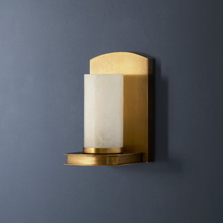 Roly wall sconce in antiqued brass with an alabaster tube