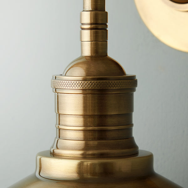 Whizzer wall sconce in antiqued brass