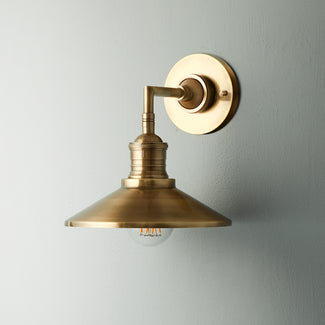 Whizzer wall sconce in antiqued brass
