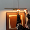 Smaller Marcel cordless picture light in antique brass finish